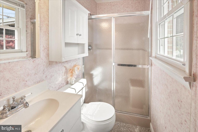 bathroom featuring toilet, walk in shower, and vanity