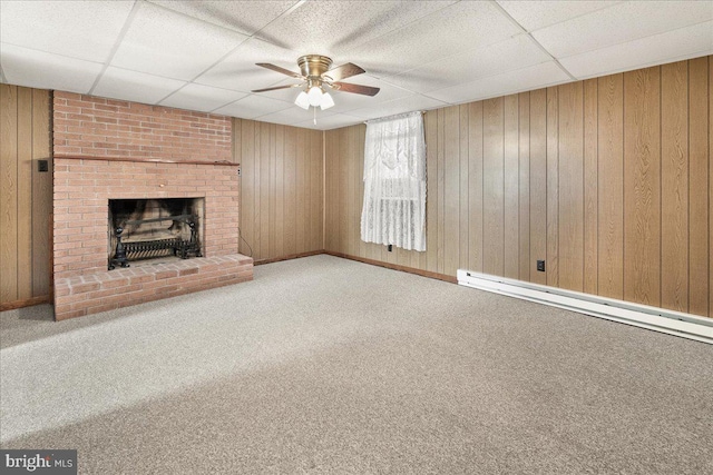 unfurnished living room featuring wooden walls and carpet flooring