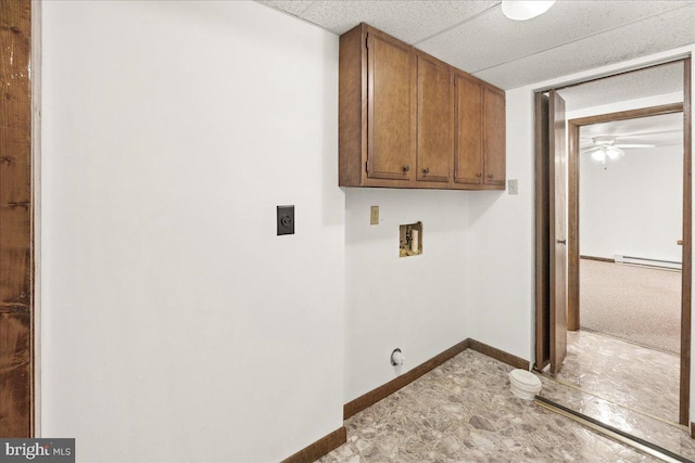 laundry room with a baseboard heating unit, ceiling fan, electric dryer hookup, washer hookup, and cabinets