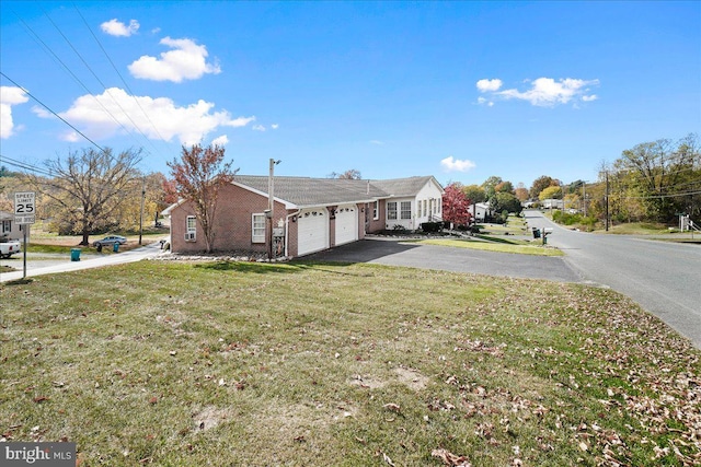 view of property exterior featuring a garage and a lawn