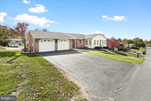 single story home featuring a front yard and a garage