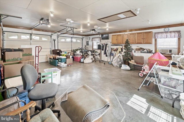 garage with a garage door opener, cooling unit, and ceiling fan