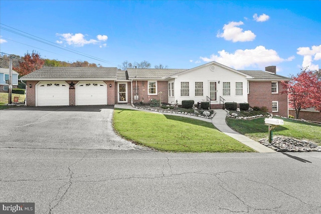 single story home featuring a front lawn and a garage