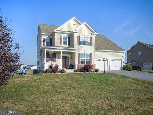 view of front facade featuring covered porch, a front lawn, and central AC unit