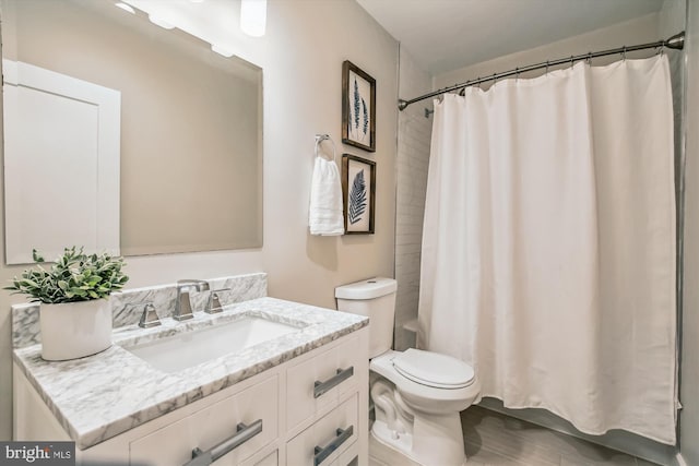 full bathroom with vanity, toilet, shower / bathtub combination with curtain, and hardwood / wood-style floors