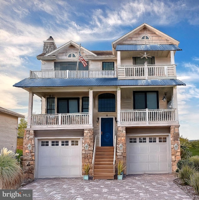 view of front of home with a garage and a balcony