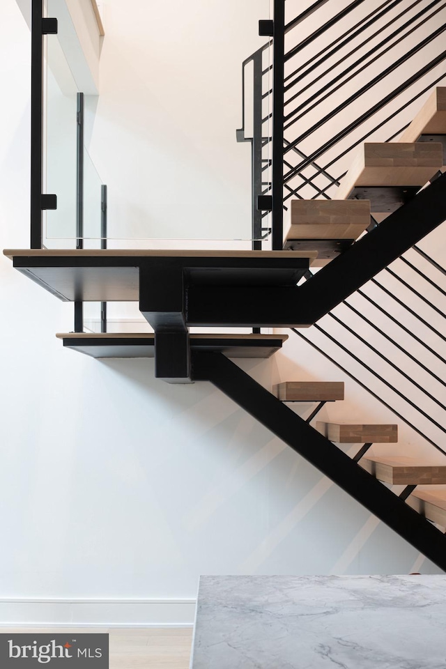 staircase with hardwood / wood-style flooring