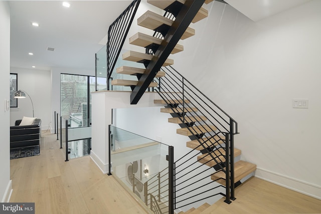 stairway with hardwood / wood-style flooring