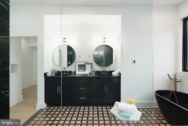 bathroom with vanity, hardwood / wood-style flooring, and a bathtub