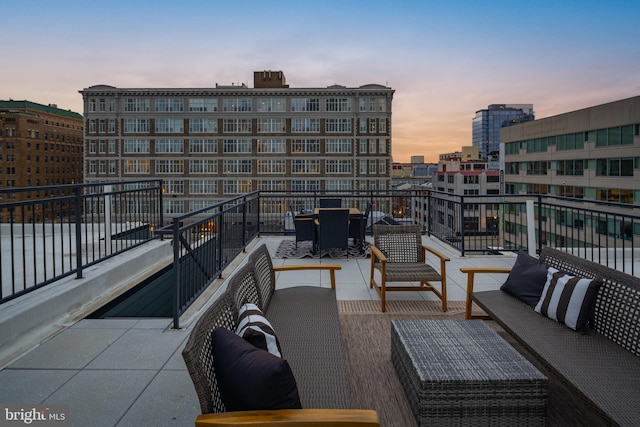 balcony at dusk with an outdoor hangout area