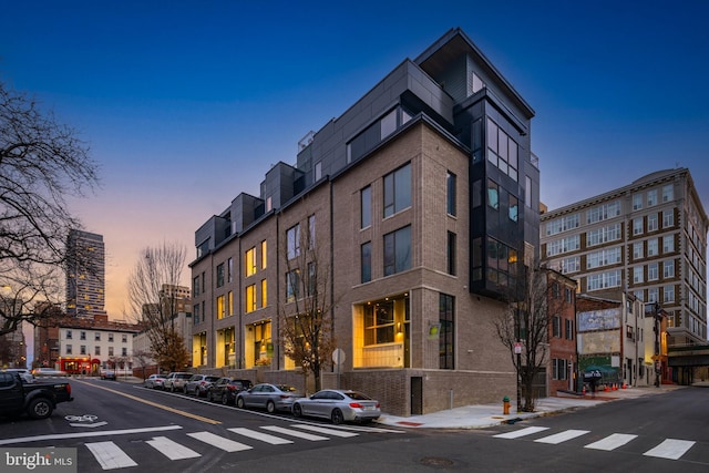 view of outdoor building at dusk