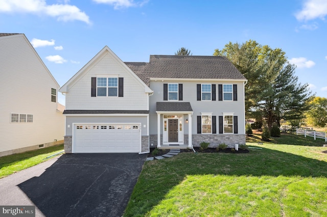 view of front of property featuring a garage and a front lawn