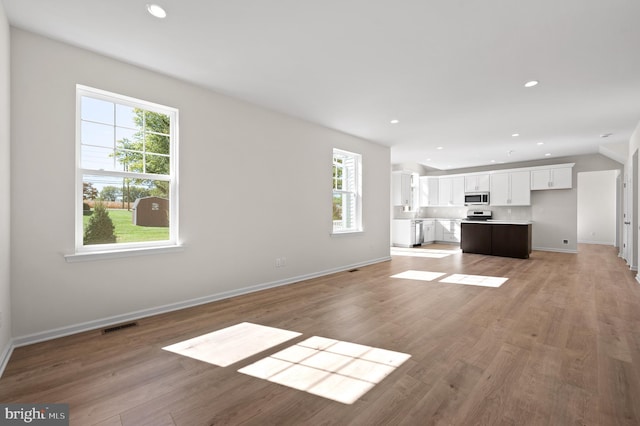 unfurnished living room featuring hardwood / wood-style flooring