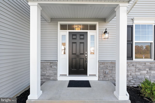 doorway to property featuring covered porch