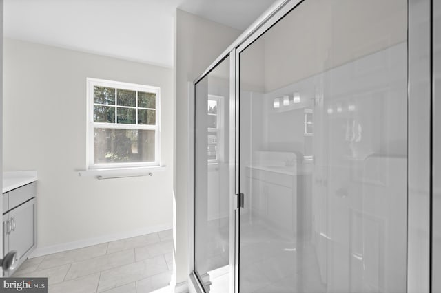 bathroom featuring vanity, tile patterned flooring, and an enclosed shower