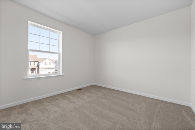 unfurnished room with light colored carpet