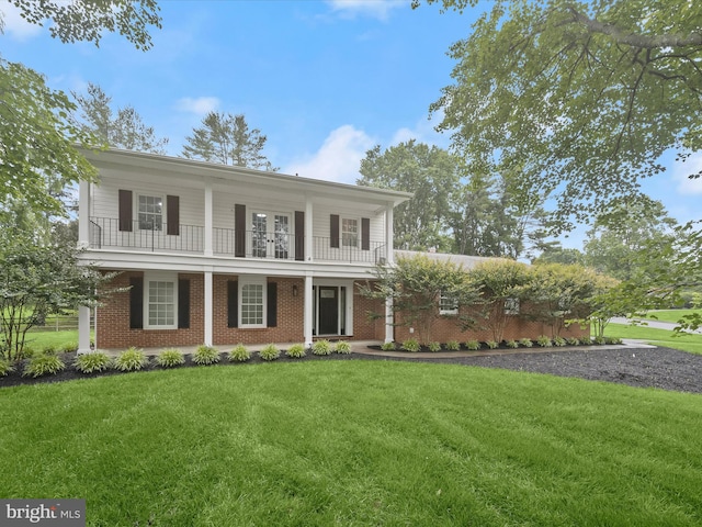 8018 Martown Rd, Laurel, MD 20723 - view of front of home with brick siding, a porch, a front lawn, and a balcony