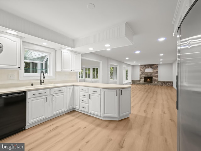 8018 Martown Rd, Laurel, MD 20723 - kitchen with black dishwasher, high quality fridge, light wood finished floors, white cabinetry, and plenty of natural light