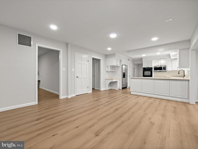 8018 Martown Rd, Laurel, MD 20723 - unfurnished living room featuring recessed lighting and light wood-style flooring