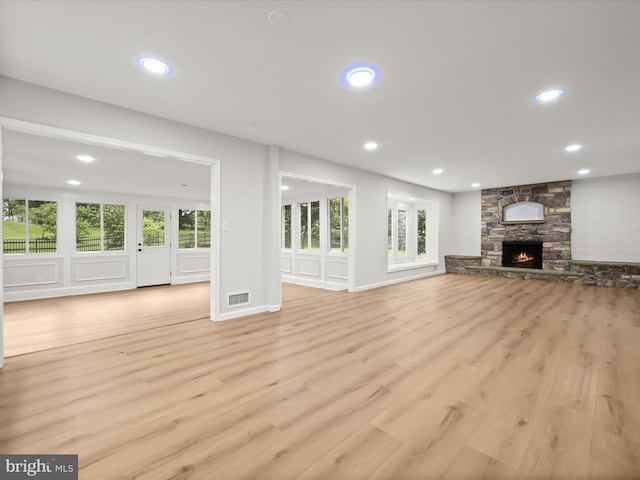 8018 Martown Rd, Laurel, MD 20723 - unfurnished living room featuring light wood-style flooring, recessed lighting, and a stone fireplace