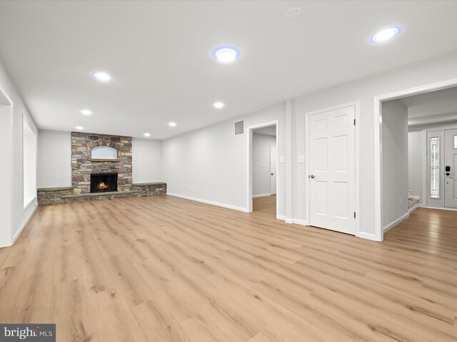 8018 Martown Rd, Laurel, MD 20723 - unfurnished living room with light wood finished floors, a stone fireplace, and recessed lighting