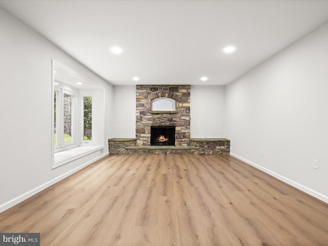 8018 Martown Rd, Laurel, MD 20723 - unfurnished living room featuring wood finished floors, recessed lighting, and a stone fireplace