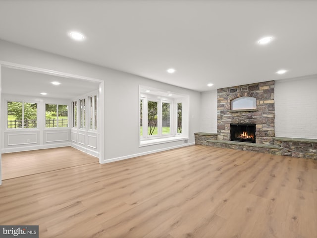 8018 Martown Rd, Laurel, MD 20723 - unfurnished living room with wood finished floors, a stone fireplace, and recessed lighting