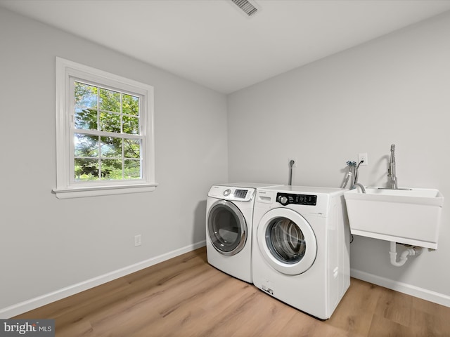 8018 Martown Rd, Laurel, MD 20723 - laundry area with washing machine and clothes dryer and light wood finished floors