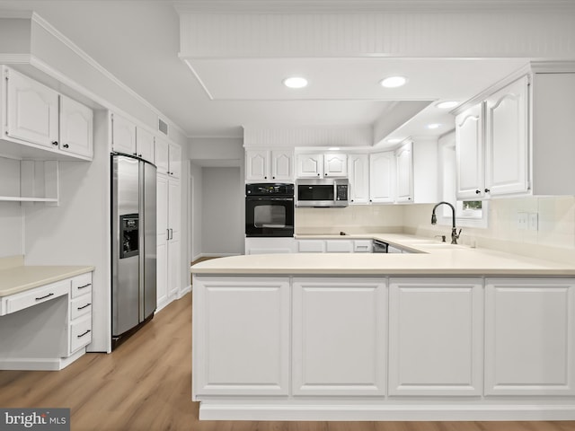 8018 Martown Rd, Laurel, MD 20723 - kitchen featuring black appliances, a peninsula, white cabinetry, light countertops, and recessed lighting
