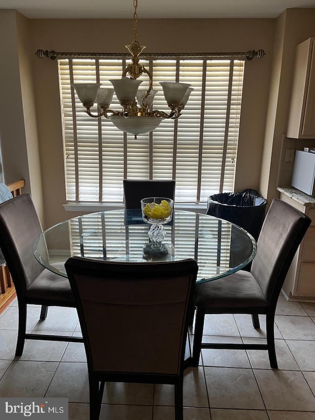 dining area featuring a chandelier and light tile patterned floors