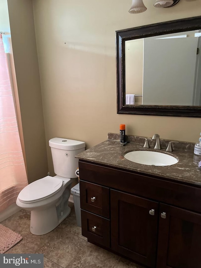 bathroom with vanity, toilet, and a shower with shower curtain