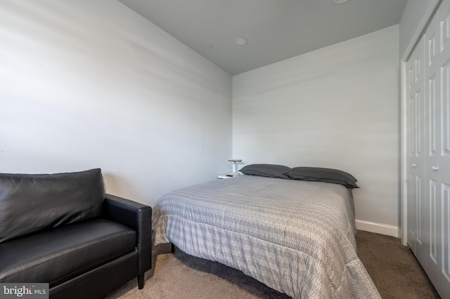 bedroom featuring baseboards, carpet flooring, and a closet