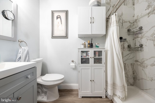 bathroom featuring vanity, a shower with shower curtain, wood-type flooring, and toilet