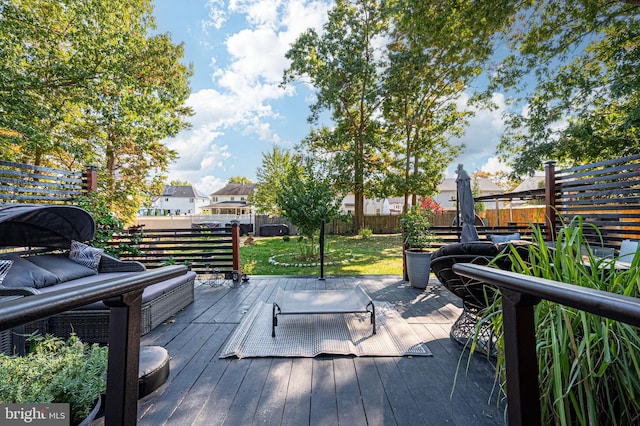 wooden deck with outdoor lounge area and a lawn