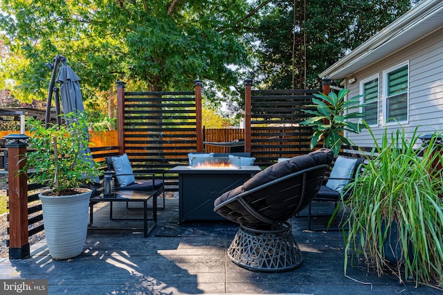 view of patio with a fire pit and a deck