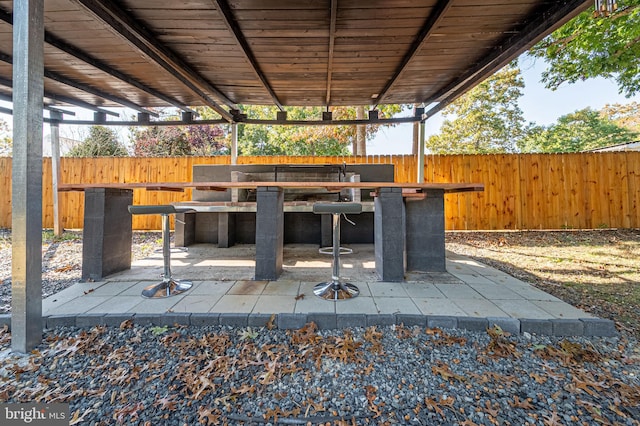 view of patio with a fenced backyard and outdoor dry bar