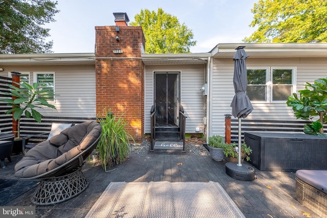 rear view of property featuring central AC and a wooden deck