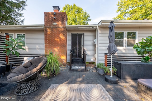 back of house featuring a chimney, cooling unit, and a deck