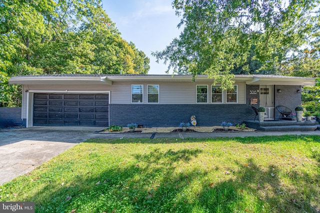 ranch-style house with a garage, brick siding, a front lawn, and concrete driveway