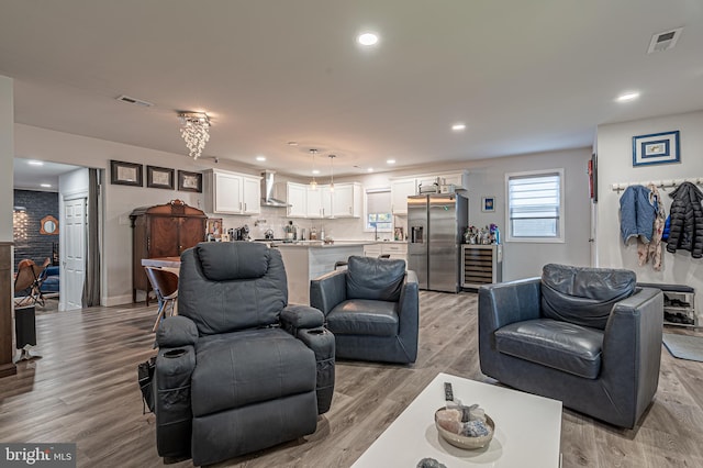 living room featuring light wood-type flooring and beverage cooler