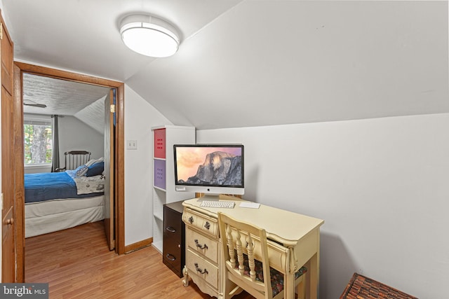 office area with light hardwood / wood-style flooring and lofted ceiling