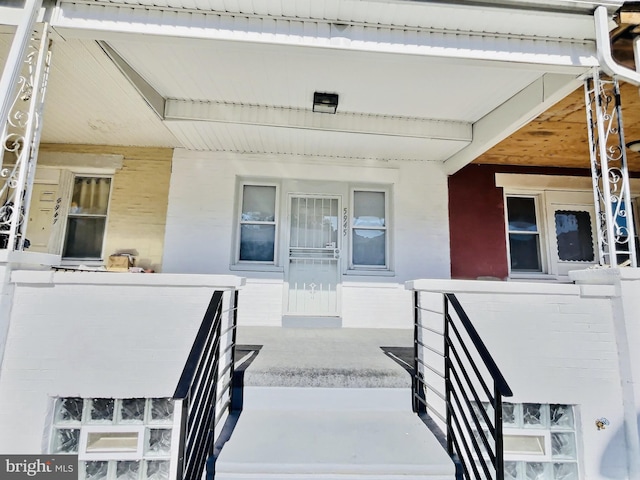 view of exterior entry with a porch