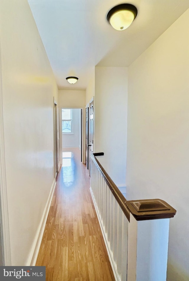 hallway with light hardwood / wood-style flooring