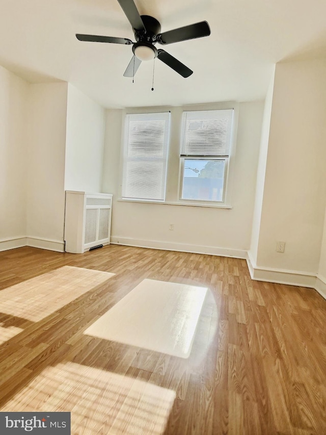 spare room with hardwood / wood-style flooring and ceiling fan