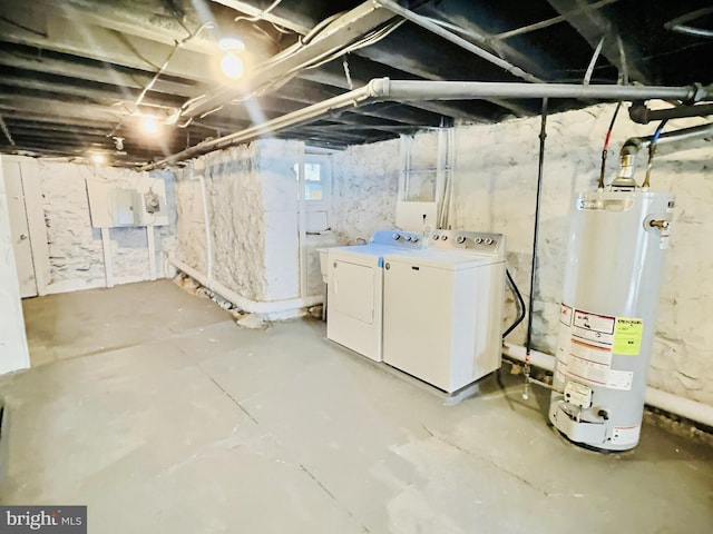 basement featuring water heater and washer and clothes dryer