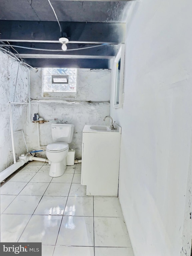 bathroom with toilet, curtained shower, vanity, and tile patterned floors