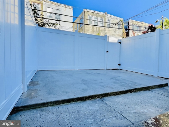 view of gate featuring a patio