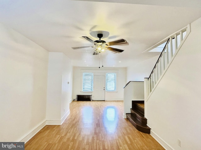 foyer entrance with light hardwood / wood-style floors and ceiling fan