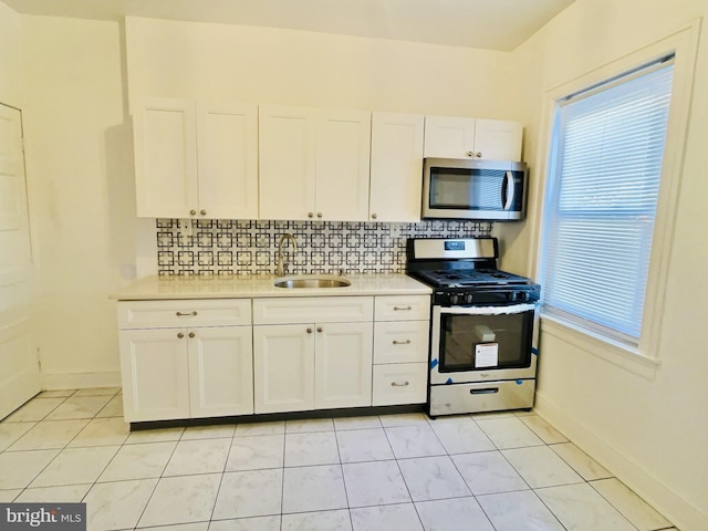 kitchen featuring white cabinetry, tasteful backsplash, stainless steel appliances, and sink