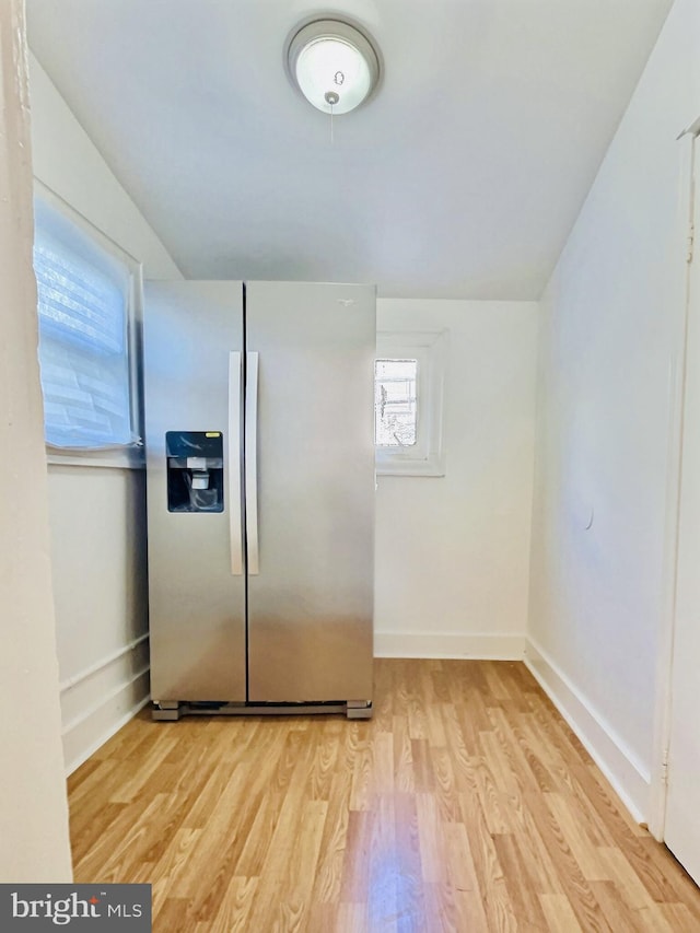 kitchen with light hardwood / wood-style floors and stainless steel fridge